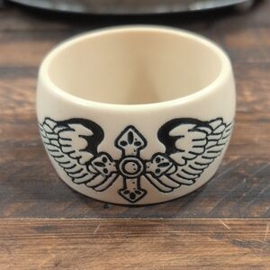 Cream Ring Bracelet with Black Winged Cross Design